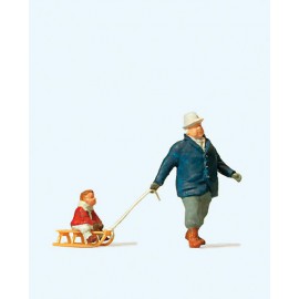 Man pulling child on sled